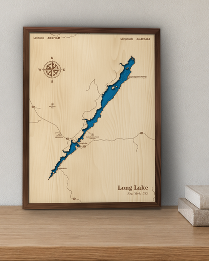 Long Lake Adirondack wood map in a walnut frame standing on a wooden sideboard against a wall for scale