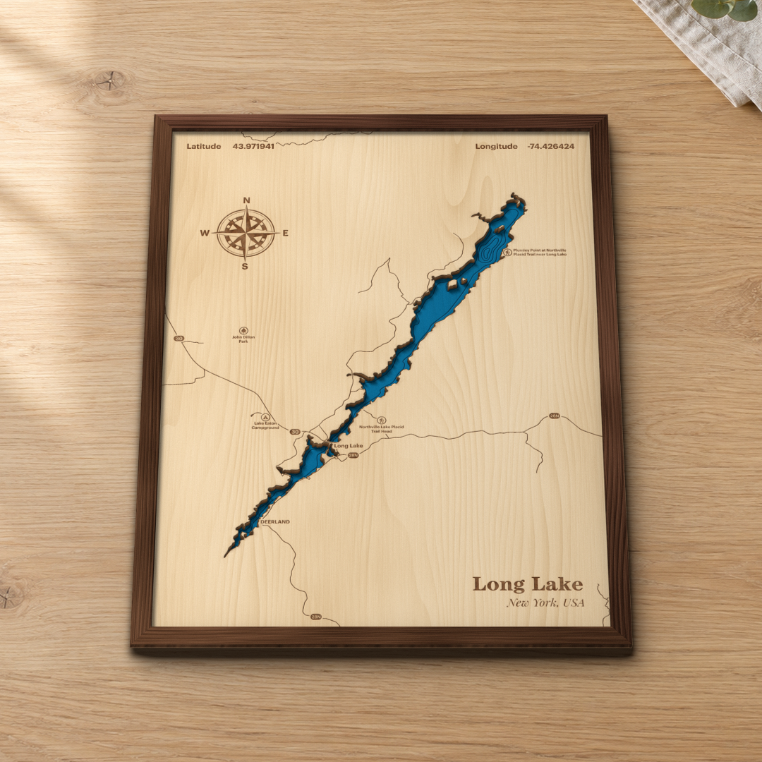 Long Lake wood map lying flat on a wooden tabletop, showing the Raquette River lake, Route 30 and depth contours