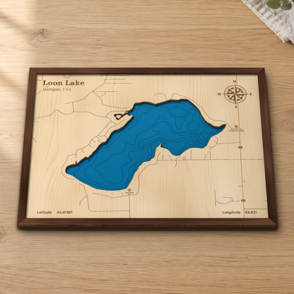 Loon Lake wood map lying flat on a wooden tabletop, showing the lake's steep depth contours and M-65