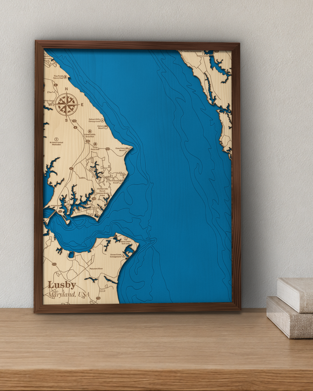 Lusby wood map in a walnut frame standing on a wooden sideboard against a wall for scale