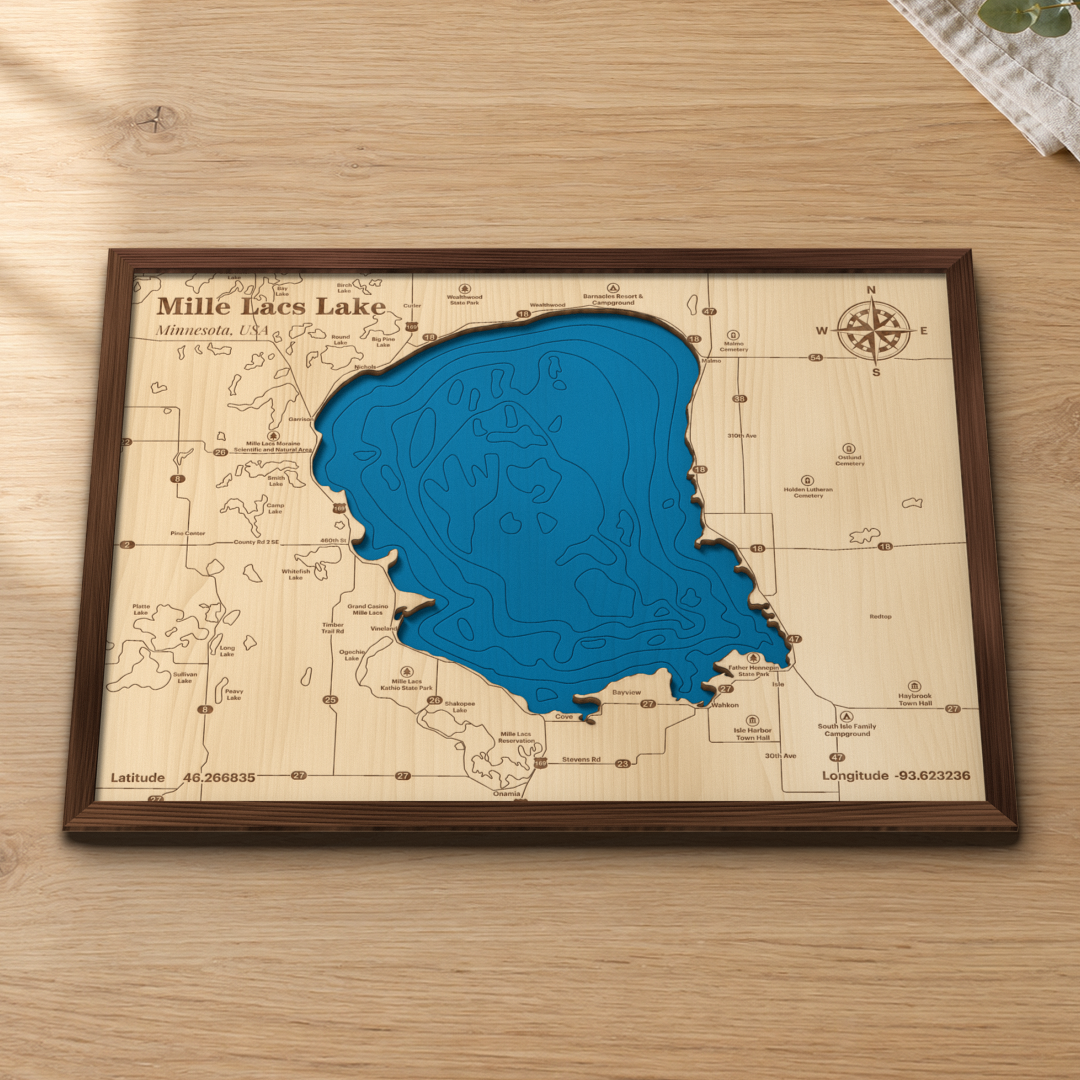 Mille Lacs Lake wood map lying flat on a wooden tabletop, showing the depth contours, Garrison, Isle and Father Hennepin State Park engraved in