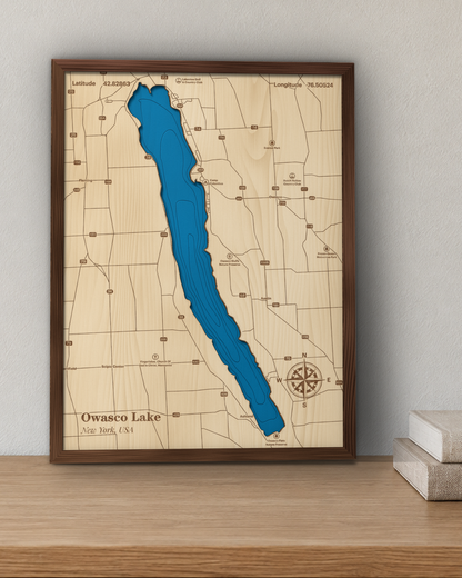 Owasco Lake wood map in a walnut frame standing on a wooden sideboard against a wall for scale