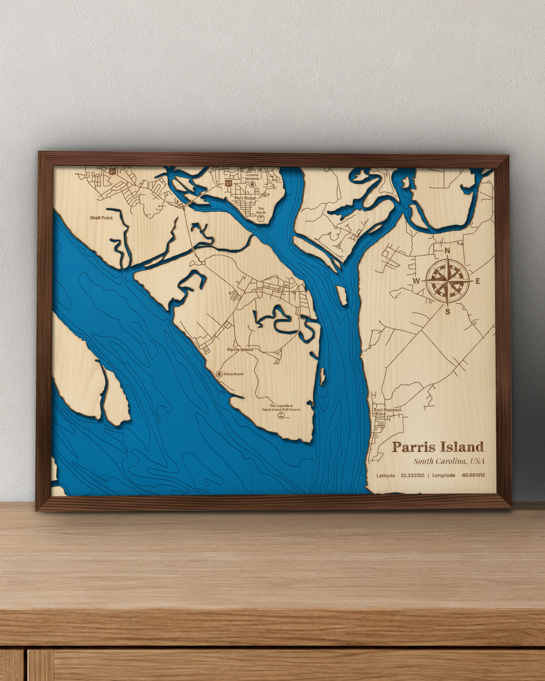Parris Island wood map in a walnut frame standing on a wooden sideboard against a wall for scale