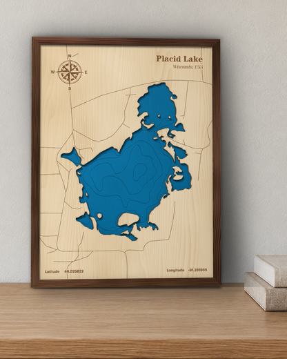 Placid Lake wood map in a walnut frame standing on a wooden sideboard against a wall for scale