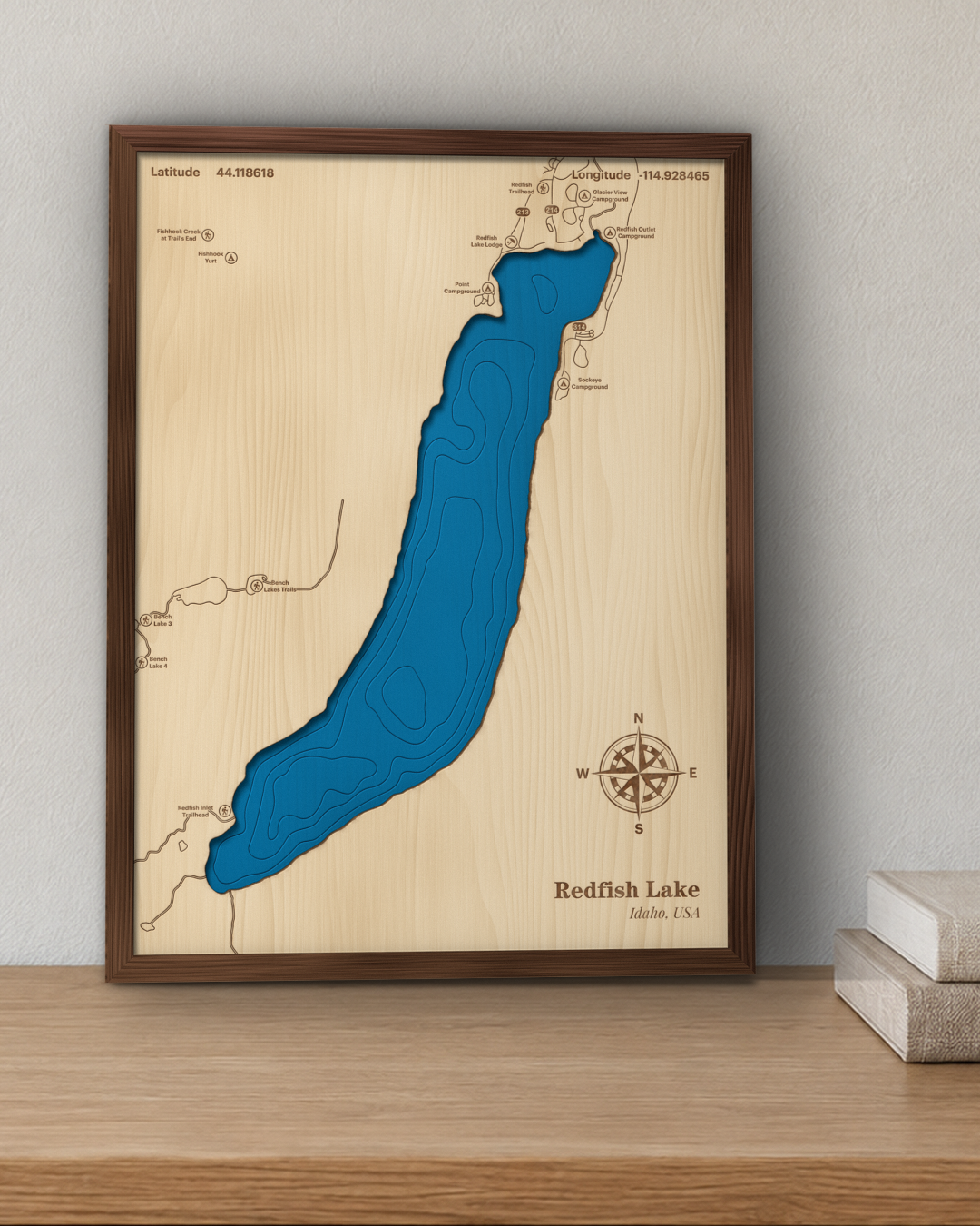 Redfish Lake wood map in a walnut frame standing on a wooden sideboard against a wall for scale