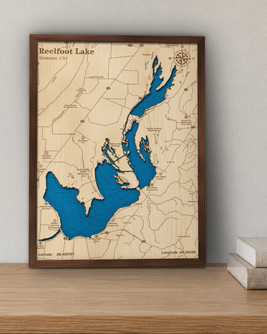 Reelfoot Lake wood map in a walnut frame standing on a wooden sideboard against a wall for scale