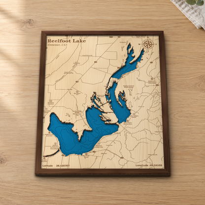 Reelfoot Lake wood map lying flat on a wooden tabletop, showing the lake's basins and depth contours with Samburg, Reelfoot Lake State Park and the wildlife refuge engraved in