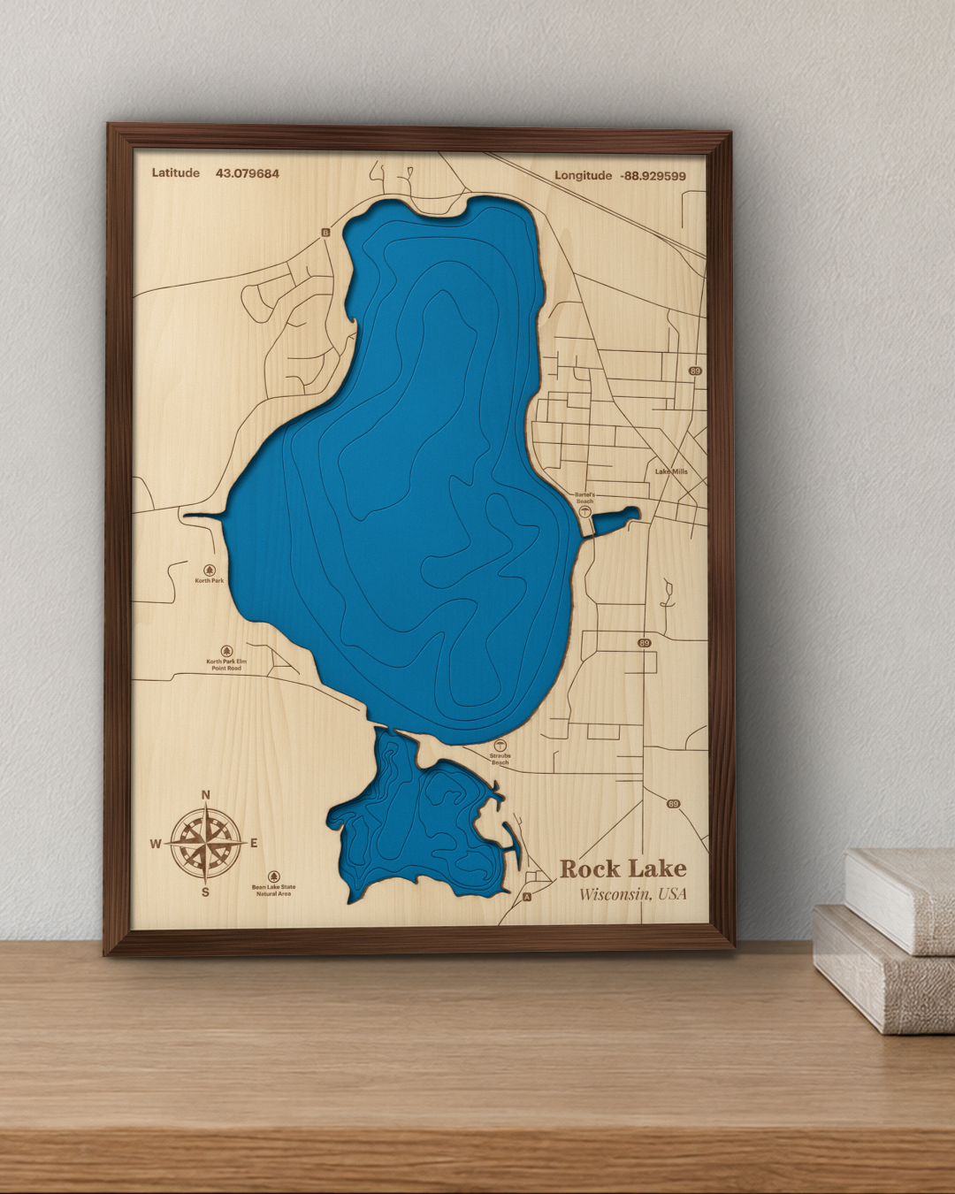 Rock Lake wood map in a walnut frame standing on a wooden sideboard against a wall for scale