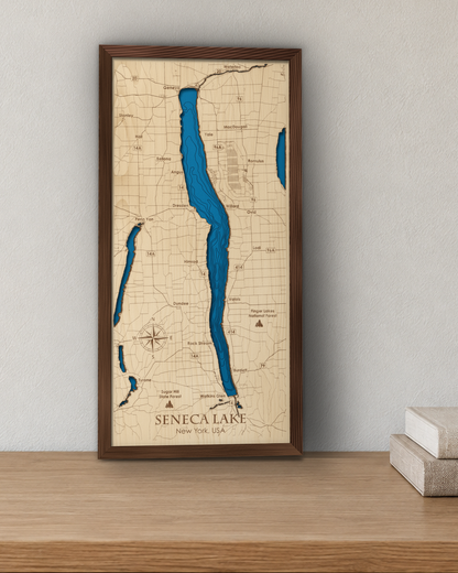 Seneca Lake wood map in a walnut frame standing on a wooden sideboard against a wall for scale