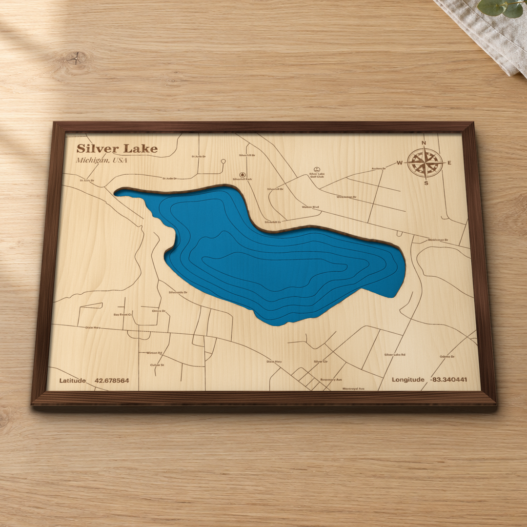 Silver Lake wood map lying flat on a wooden tabletop, showing the depth contours, Silver Lake Golf Club and the Waterford streets engraved in