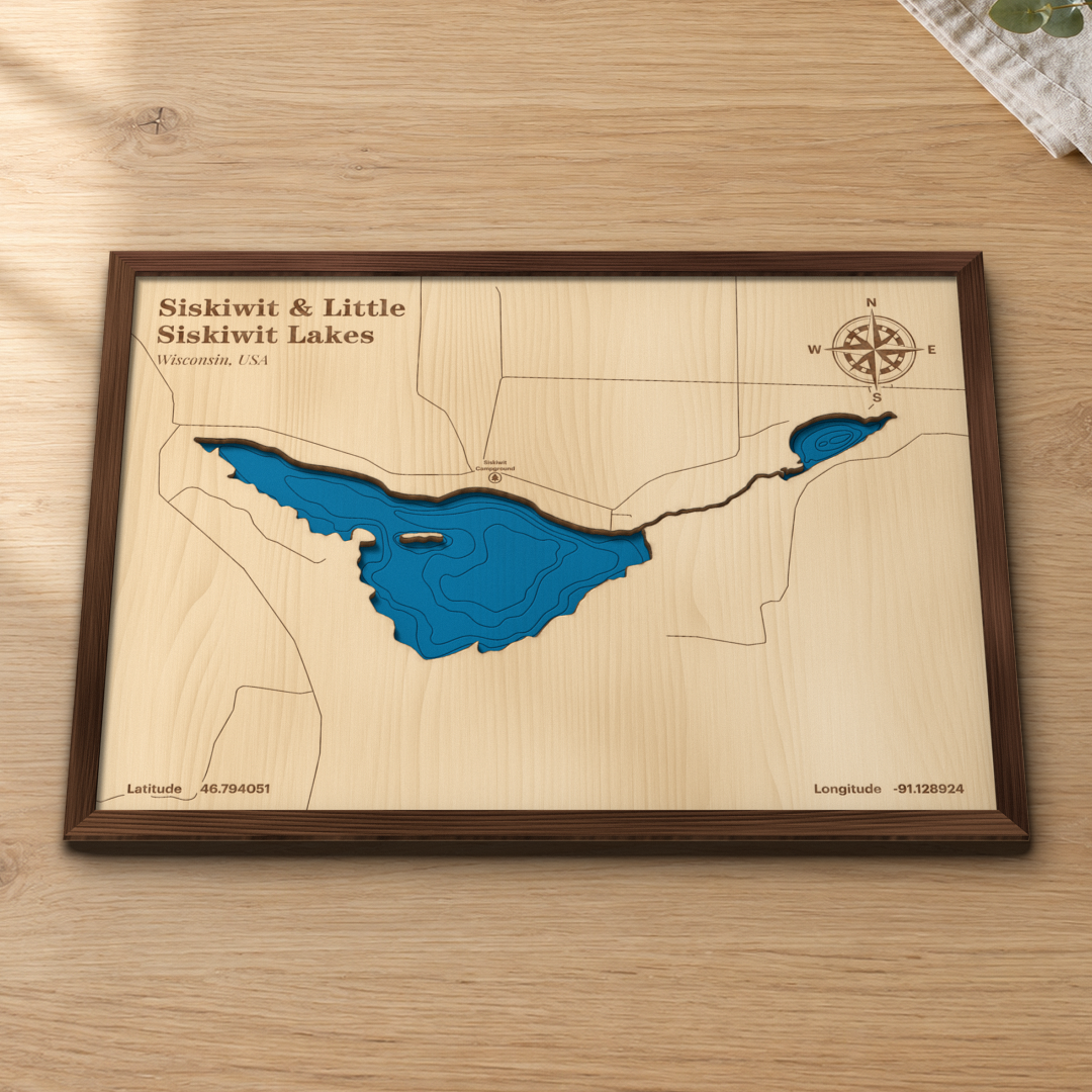 Siskiwit & Little Siskiwit Lakes wood map lying flat on a wooden tabletop, showing the depth contours of both lakes and the narrow channel linking them