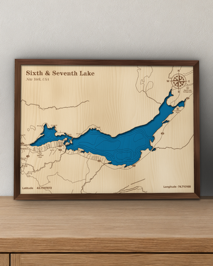 Sixth & Seventh Lake wood map in a walnut frame standing on a wooden sideboard against a wall for scale