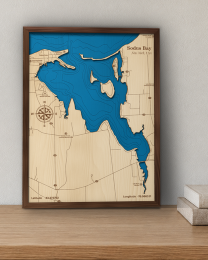 Sodus Bay wood map in a walnut frame standing on a wooden sideboard against a wall for scale