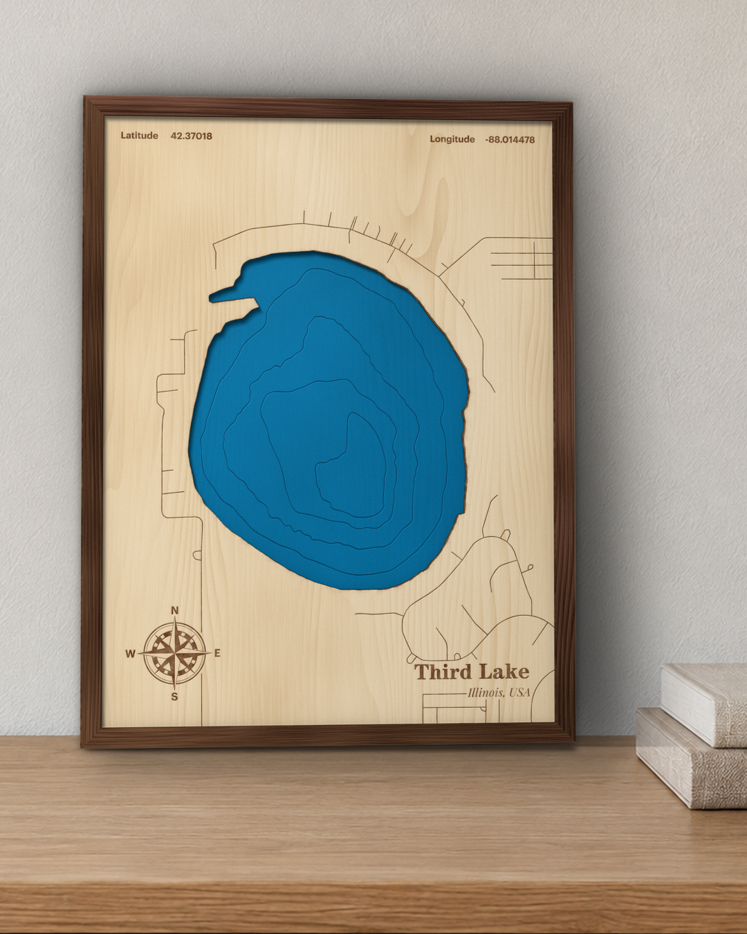 Third Lake wood map in a walnut frame standing on a wooden sideboard against a wall for scale