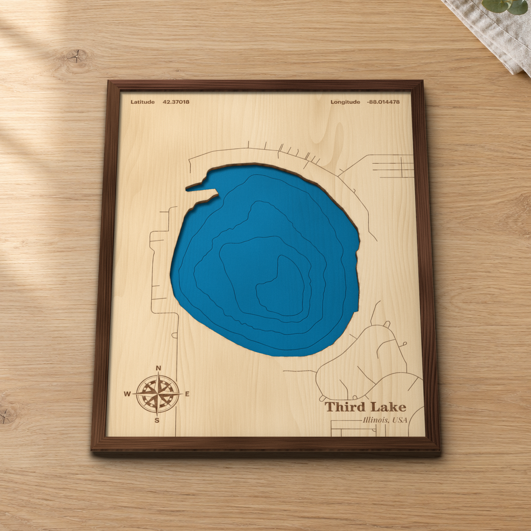 Third Lake wood map lying flat on a wooden tabletop, showing the round glacial lake and its depth contours