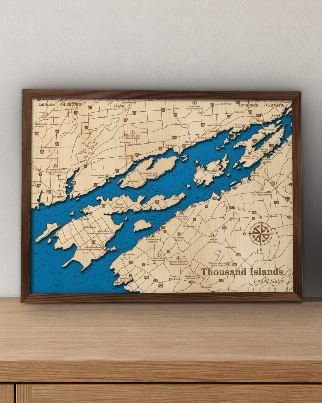 Thousand Islands wood map in a walnut frame standing on a wooden sideboard against a wall for scale