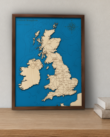 United Kingdom wood map in a walnut frame standing on a wooden sideboard against a wall for scale