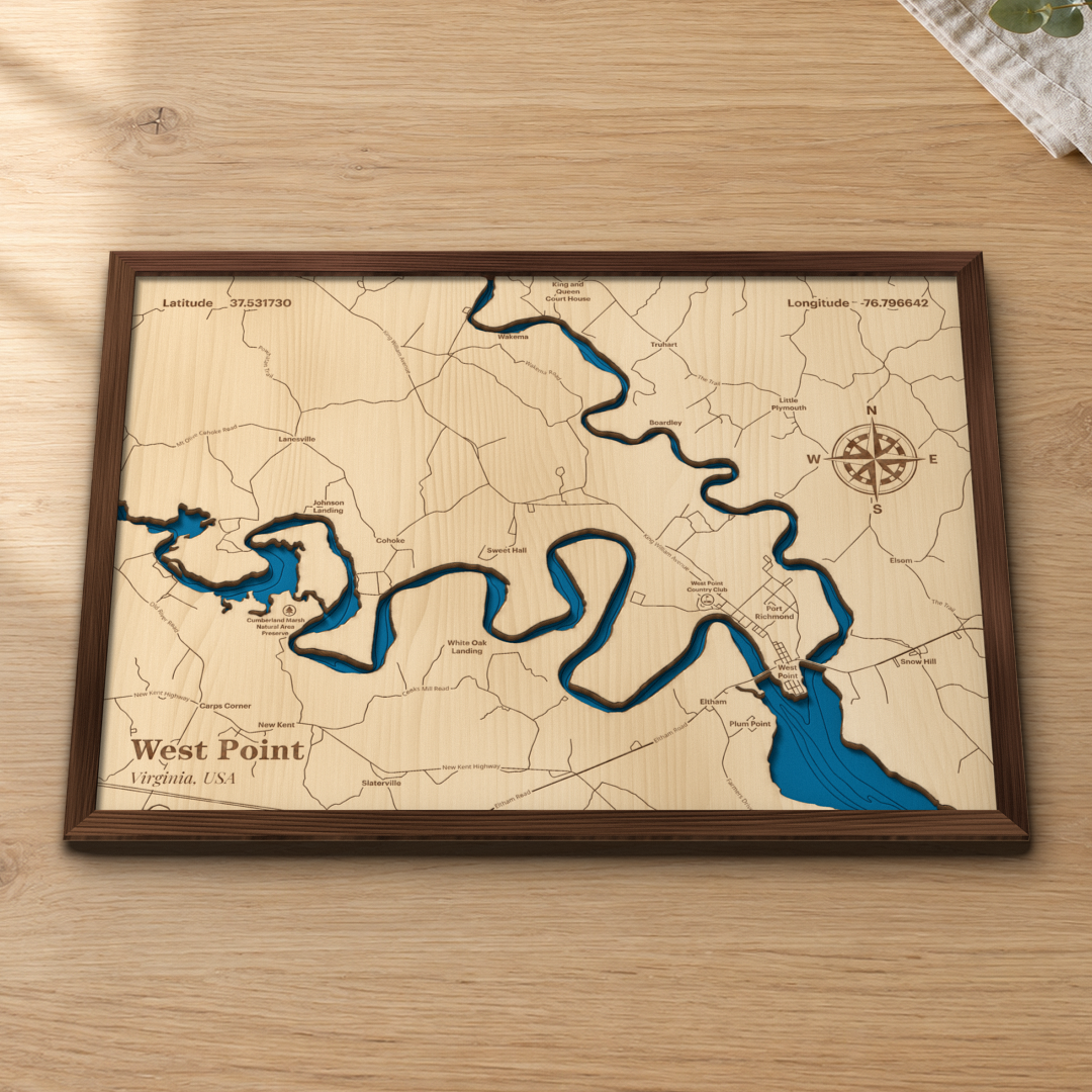 West Point wood map lying flat on a wooden tabletop, showing the winding Pamunkey River, the town of West Point and the York River